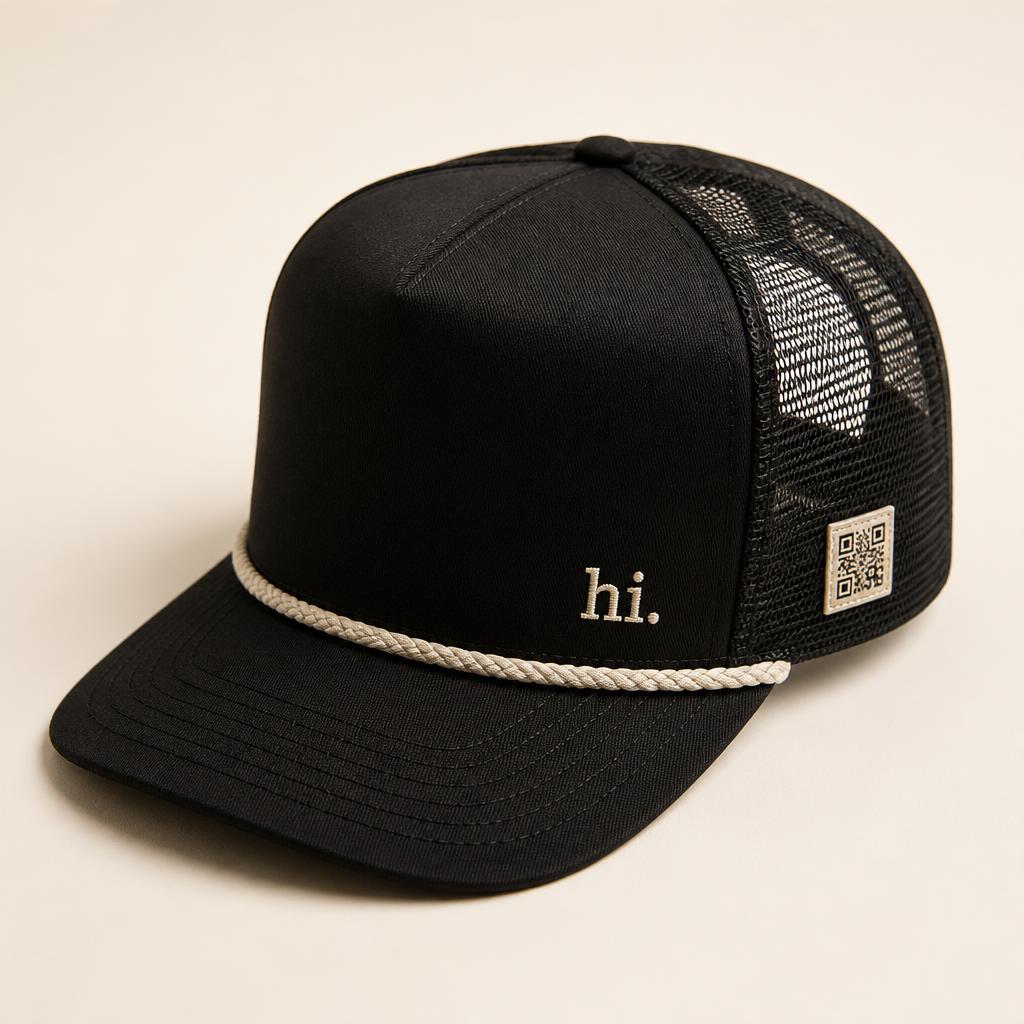 Classic Rope Trucker — black with cream rope visor and a small cream 'hi.' embroidered on the front