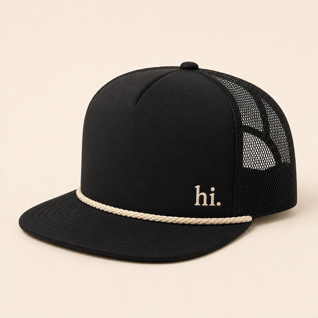 Classic Rope Trucker — black with cream rope visor and a small cream 'hi.' embroidered on the front
