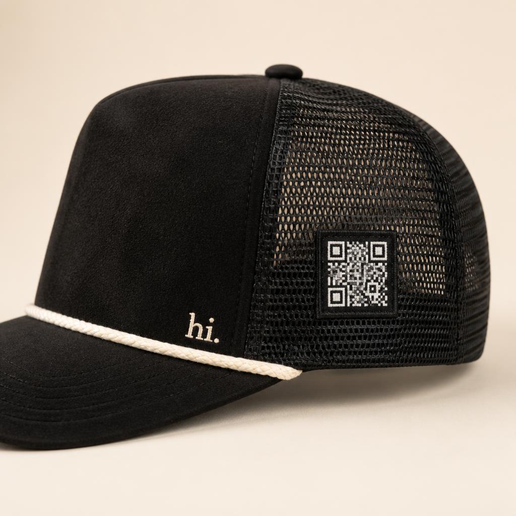 Side view of the hat showing a small woven QR-code patch stitched onto the side panel